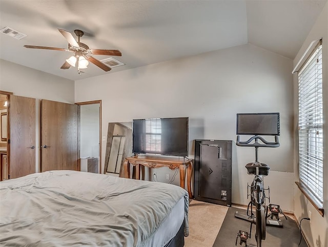 carpeted bedroom featuring visible vents, ceiling fan, and vaulted ceiling