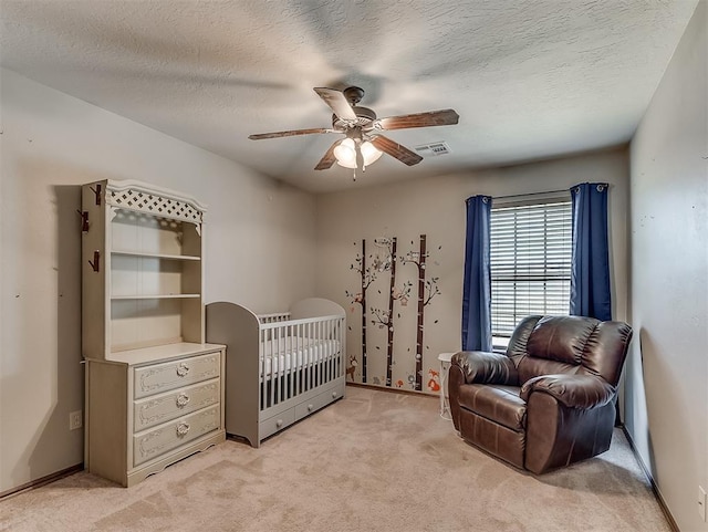 bedroom featuring baseboards, light colored carpet, visible vents, and ceiling fan