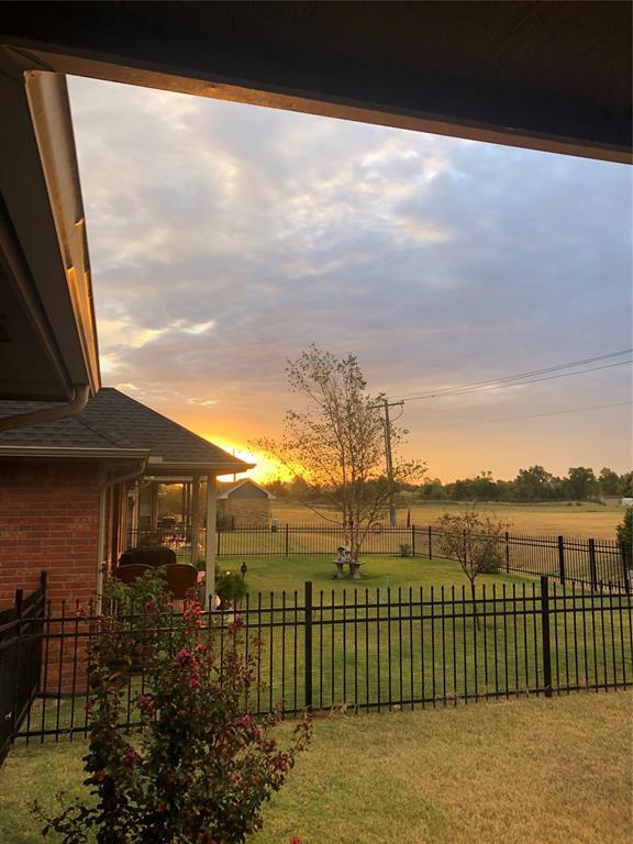 view of yard featuring a rural view and a fenced backyard