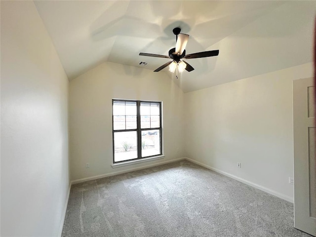 spare room featuring visible vents, ceiling fan, baseboards, lofted ceiling, and carpet floors