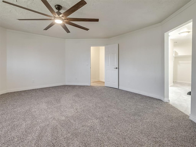 spare room with a textured ceiling, ornamental molding, and light carpet