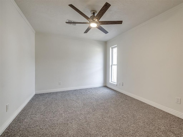 unfurnished room with baseboards, a textured ceiling, crown molding, and carpet