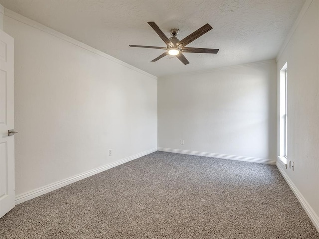 spare room featuring ornamental molding, a textured ceiling, baseboards, and carpet floors