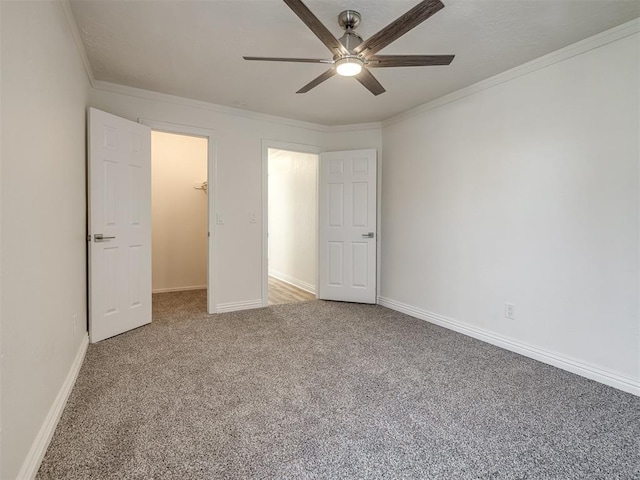 unfurnished bedroom featuring baseboards, carpet, ornamental molding, and a ceiling fan