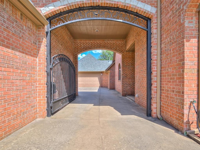 exterior space with concrete driveway, a gate, and a garage