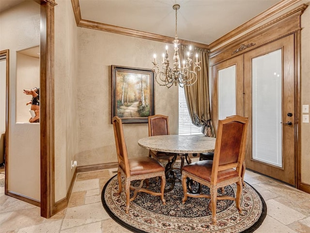 dining area with ornamental molding, baseboards, a chandelier, and stone tile flooring