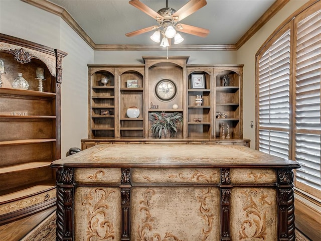 unfurnished office featuring a healthy amount of sunlight, ornamental molding, and a ceiling fan