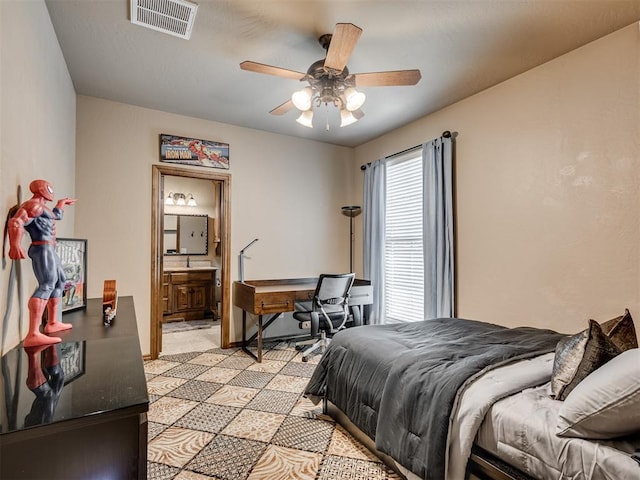 bedroom featuring a ceiling fan, visible vents, and connected bathroom