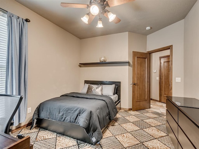 bedroom featuring baseboards and ceiling fan