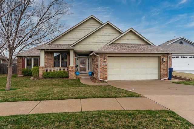 craftsman inspired home featuring a front yard, an attached garage, a shingled roof, concrete driveway, and brick siding