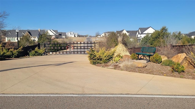 exterior space featuring a residential view and a gate