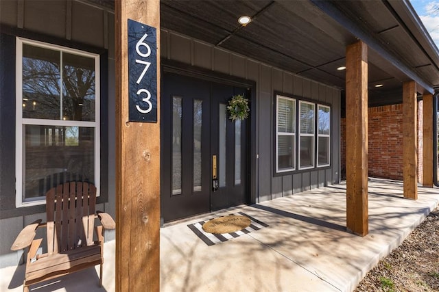 property entrance with a porch and board and batten siding