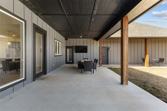 view of patio with outdoor dining area and a ceiling fan