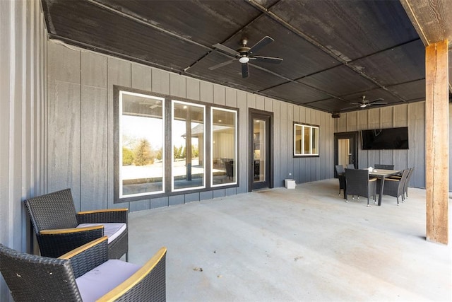 view of patio with outdoor dining area and a ceiling fan