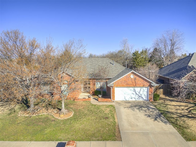 view of front of home featuring a front lawn, an attached garage, brick siding, and driveway