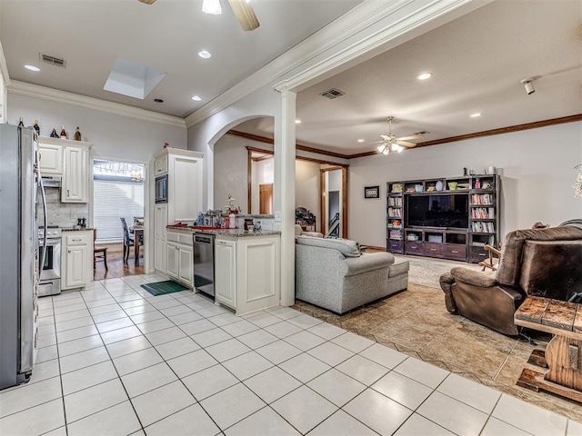 living area with light tile patterned floors, visible vents, and ceiling fan