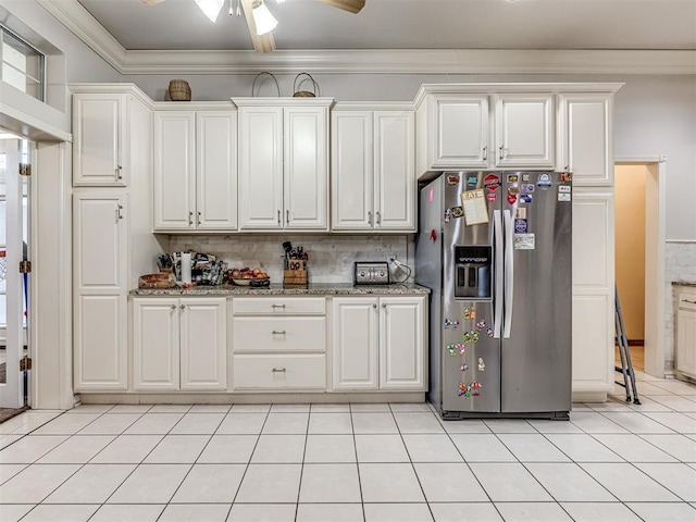 kitchen featuring ornamental molding, light tile patterned flooring, stainless steel fridge with ice dispenser, white cabinets, and decorative backsplash