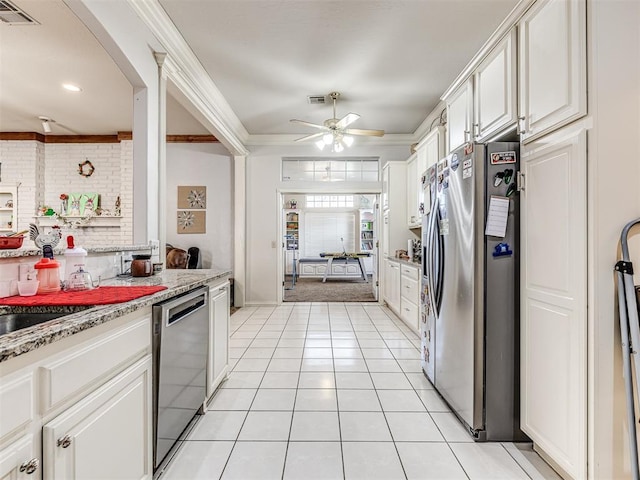 kitchen featuring visible vents, ornamental molding, white cabinetry, stainless steel appliances, and light tile patterned floors