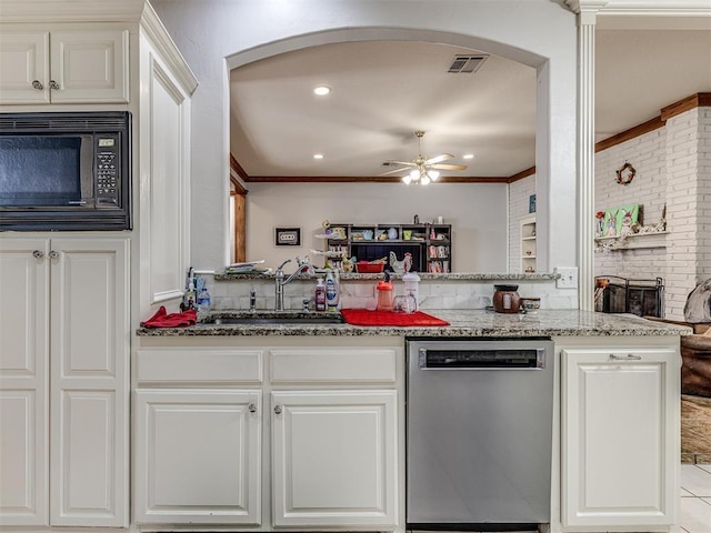 kitchen featuring visible vents, black microwave, dishwasher, arched walkways, and a sink