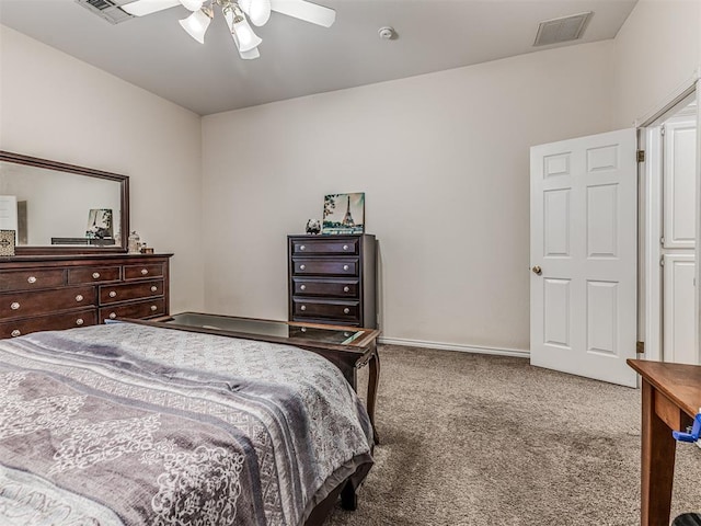 carpeted bedroom with visible vents, baseboards, and ceiling fan