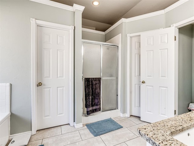 full bath featuring tile patterned floors, baseboards, and a stall shower