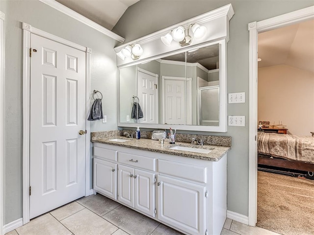 full bathroom with lofted ceiling, ensuite bathroom, tile patterned floors, and a sink