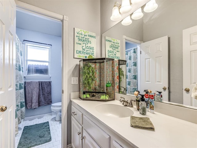 bathroom featuring a notable chandelier, toilet, vanity, and tile patterned flooring