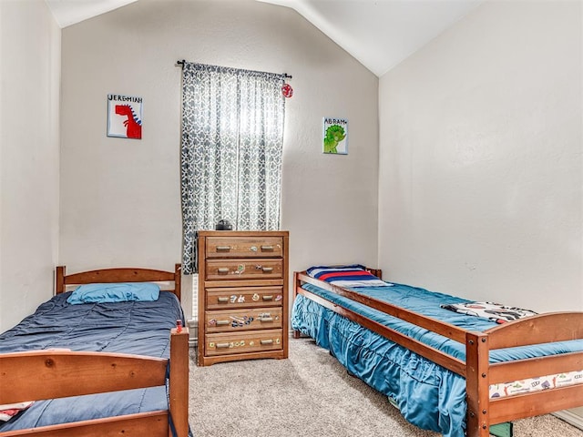 carpeted bedroom featuring lofted ceiling