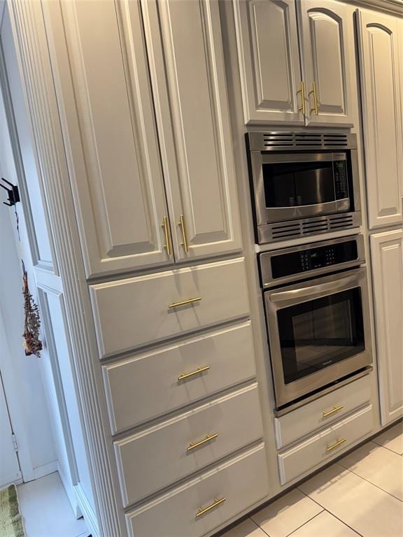 kitchen featuring light tile patterned floors and stainless steel appliances