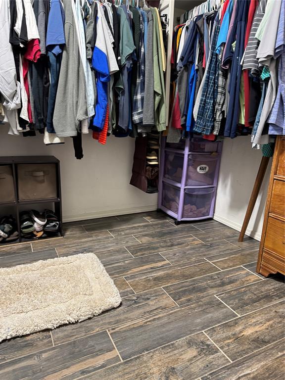 spacious closet featuring wood finish floors