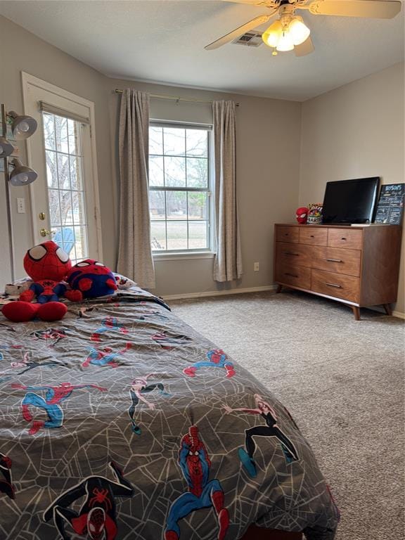 bedroom featuring visible vents, multiple windows, light colored carpet, and baseboards