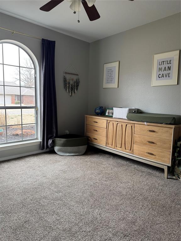 carpeted bedroom with ceiling fan