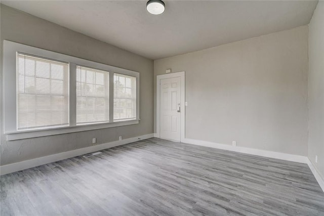 324 NW 24th St, Oklahoma City, OK 73103 - spare room with baseboards and wood finished floors