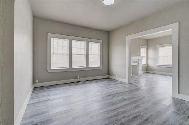 324 NW 24th St, Oklahoma City, OK 73103 - empty room with wood finished floors, baseboards, and a textured wall