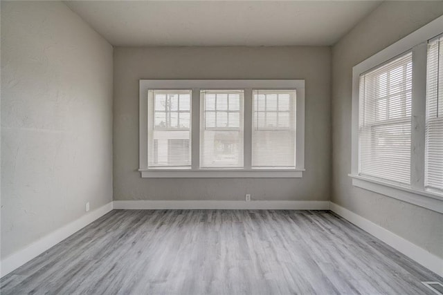 324 NW 24th St, Oklahoma City, OK 73103 - unfurnished room featuring a textured wall, visible vents, baseboards, and wood finished floors