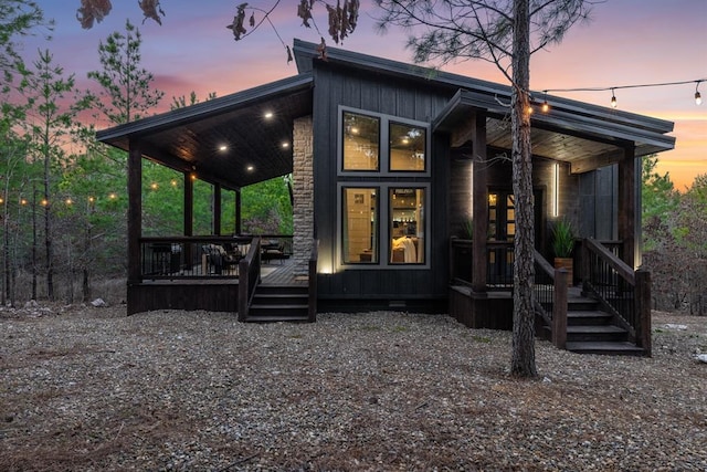 back of house at dusk with board and batten siding