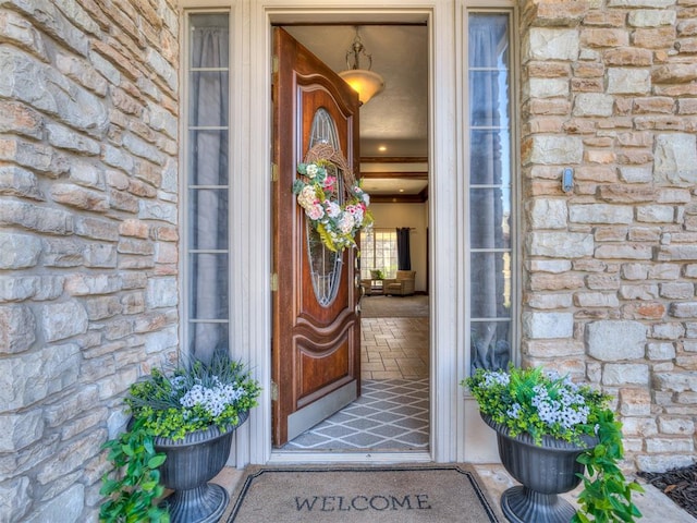 view of exterior entry featuring stone siding