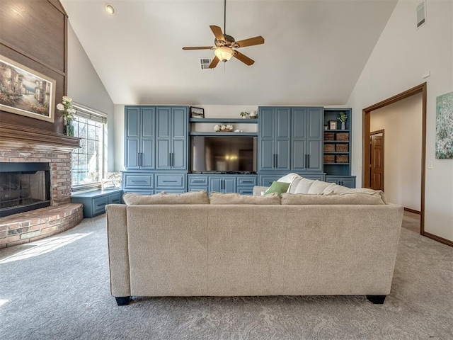 living area featuring ceiling fan, high vaulted ceiling, a fireplace, and light carpet