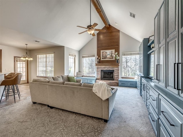 living room featuring beam ceiling, visible vents, a brick fireplace, and light carpet