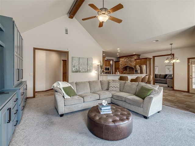 living area featuring visible vents, high vaulted ceiling, beam ceiling, ceiling fan with notable chandelier, and light colored carpet