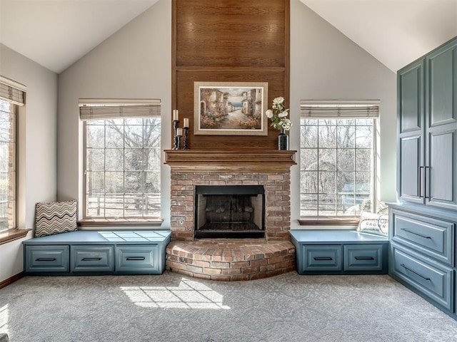 unfurnished living room with a wealth of natural light, a fireplace, high vaulted ceiling, and carpet