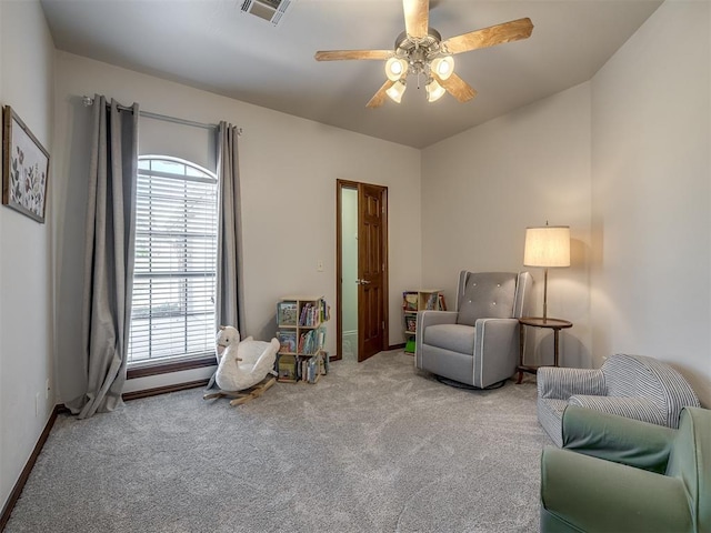 sitting room featuring ceiling fan, carpet, visible vents, and baseboards