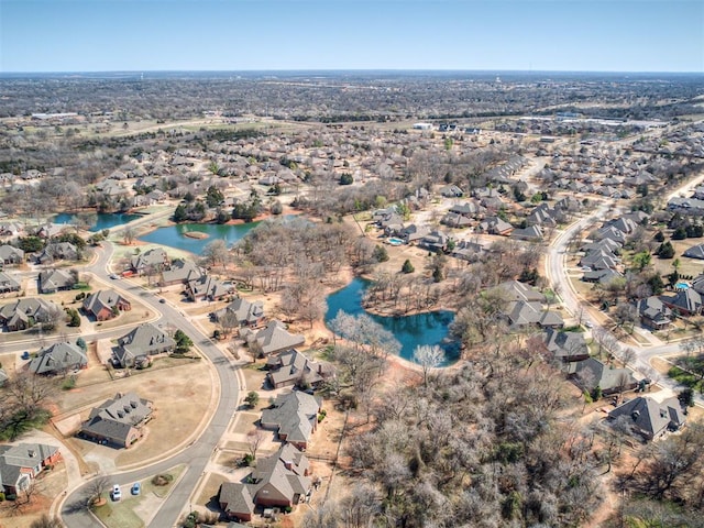 birds eye view of property featuring a water view and a residential view