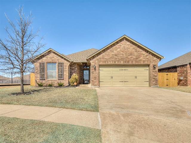 ranch-style home with brick siding, fence, concrete driveway, roof with shingles, and an attached garage