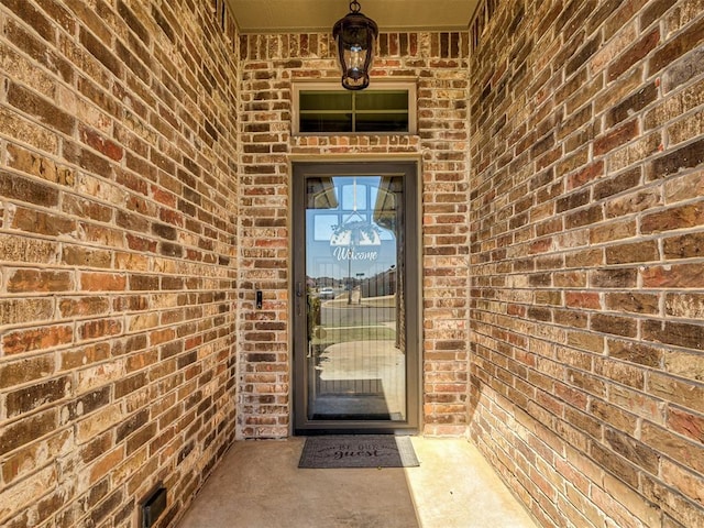 property entrance with brick siding