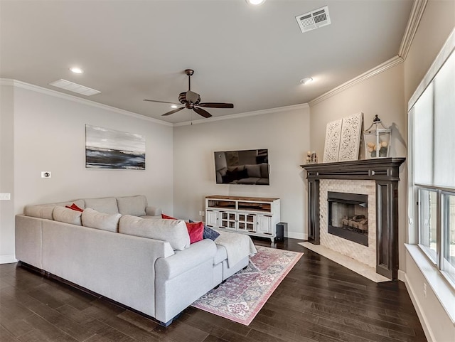 living room featuring visible vents, dark wood-type flooring, and ornamental molding