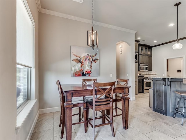 dining area featuring recessed lighting, arched walkways, crown molding, light tile patterned floors, and baseboards