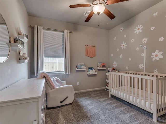 bedroom featuring visible vents, a ceiling fan, carpet floors, a nursery area, and baseboards