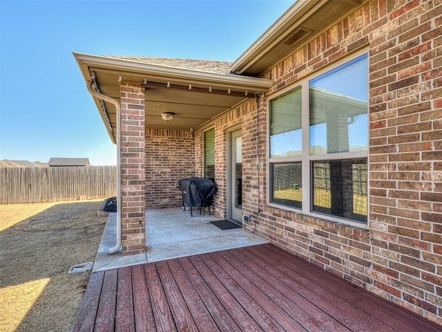 deck with a patio, fence, and grilling area