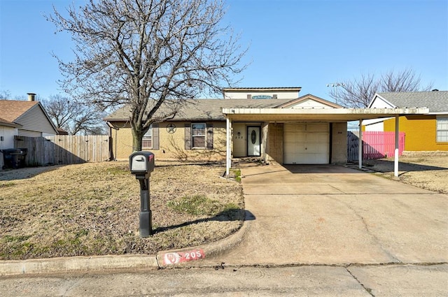 view of front of property featuring brick siding, concrete driveway, a garage, and fence